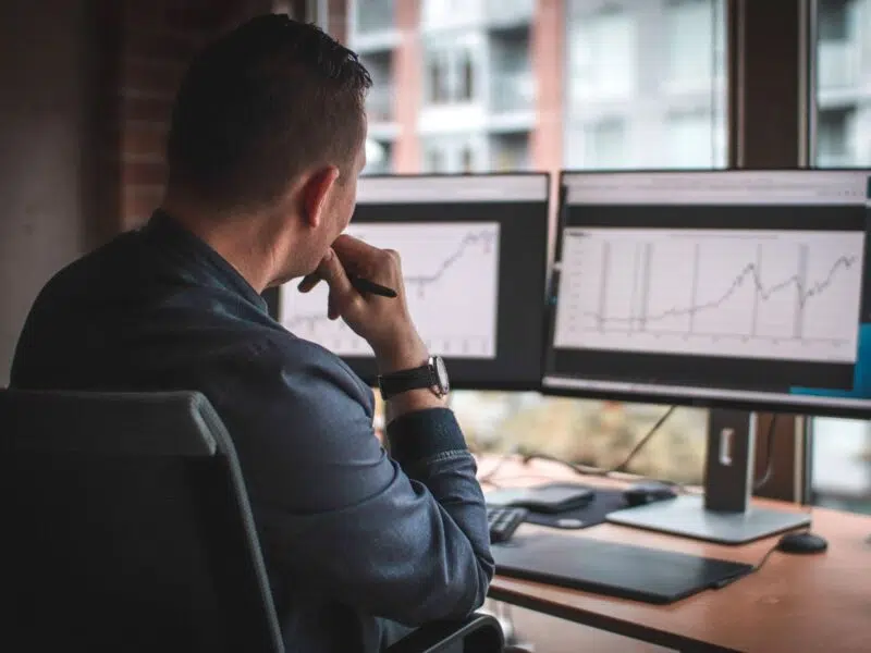 Man sat at desk looking at restaurant forecasting data