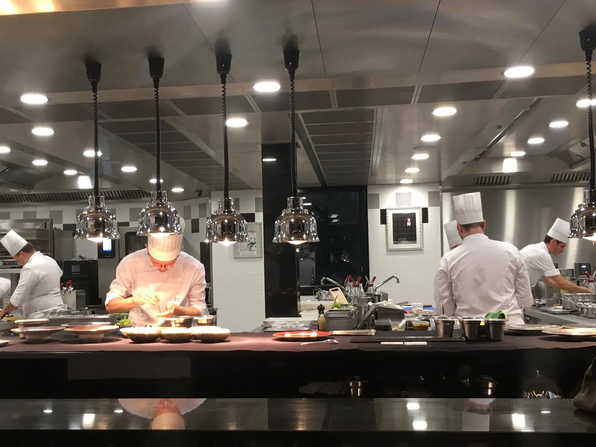 chefs preparing meals for restaurant guests