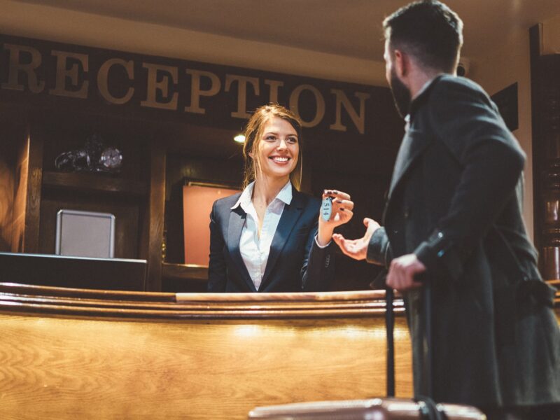 giving a room key to a hotel guest