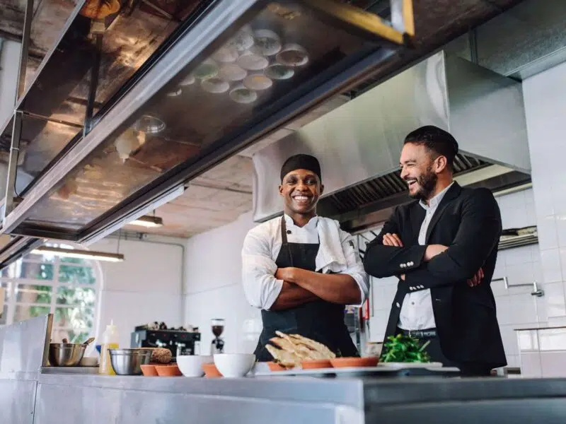 manager and kitchen staff working together