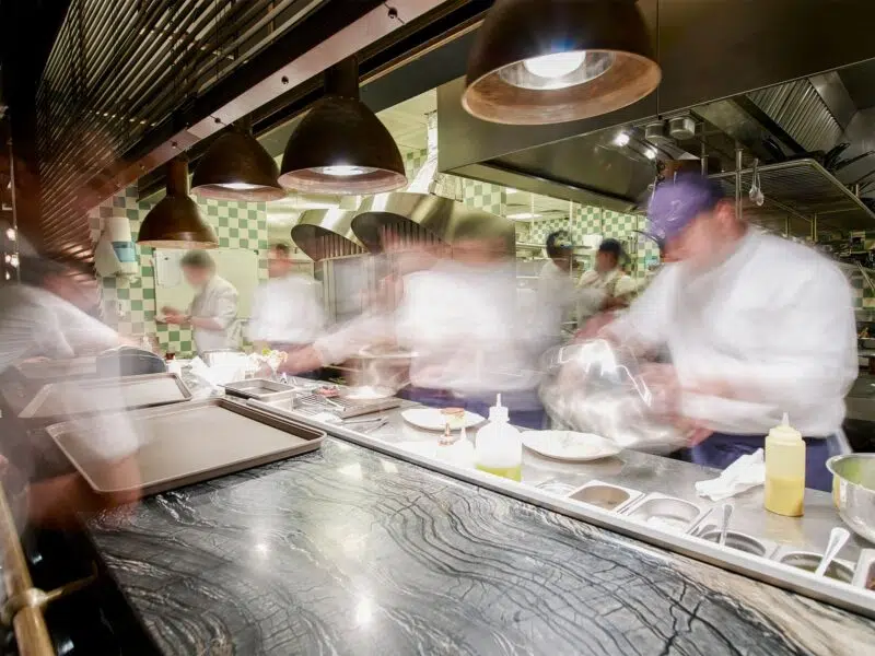 Chefs preparing food in a kitchen