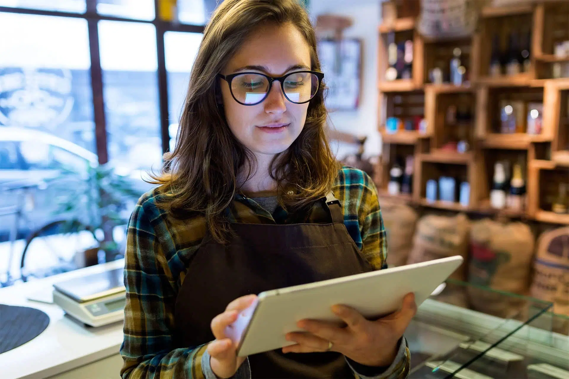 store owner doing inventory management on tablet