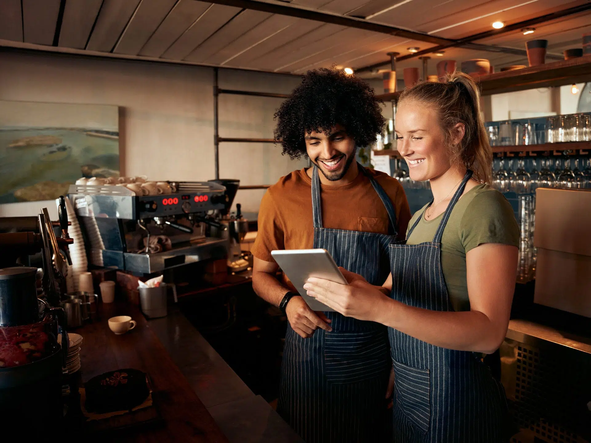 two people reading an ipad in a coffee shop