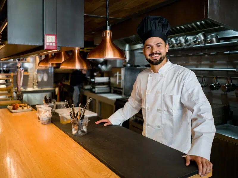 Male chef in restaurant behind bar
