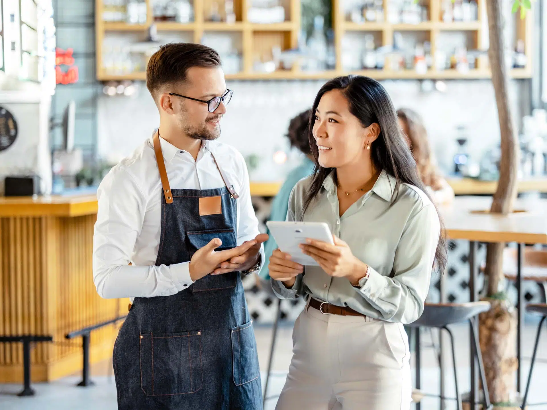 Staff talking in restaurant.