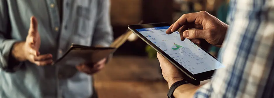 restaurant manager checking labour costs and schedules on a tablet